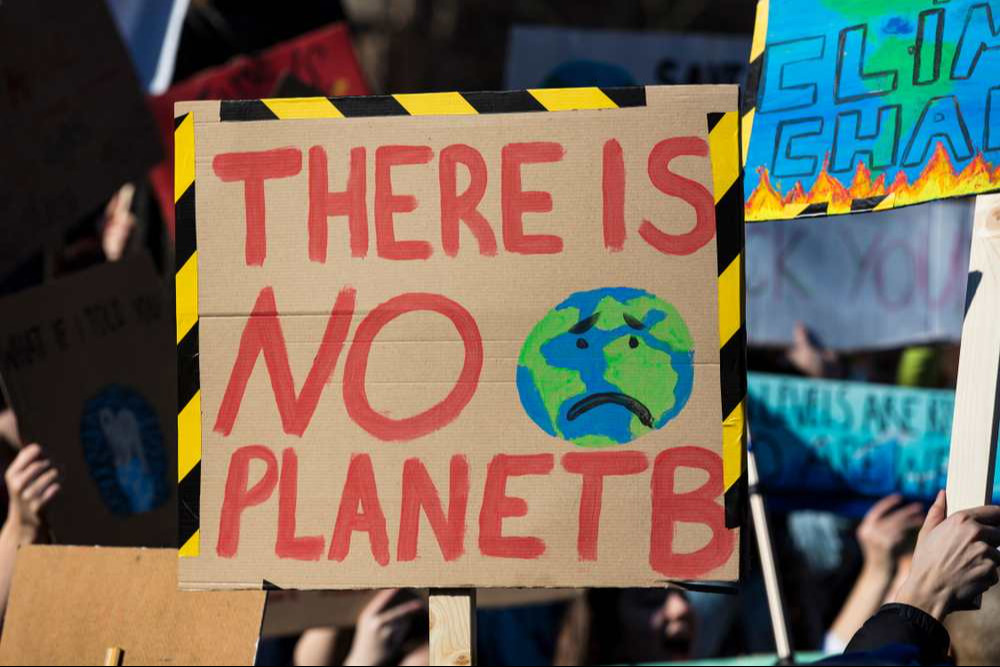 Protestors holding climate change banners at a protest Protestors holding climate change banners at a protest