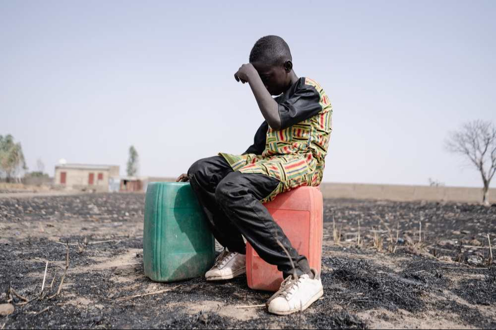 African teenager strained for walking long distance to collect clean water. African teenager strained for walking long distance to collect clean water.
